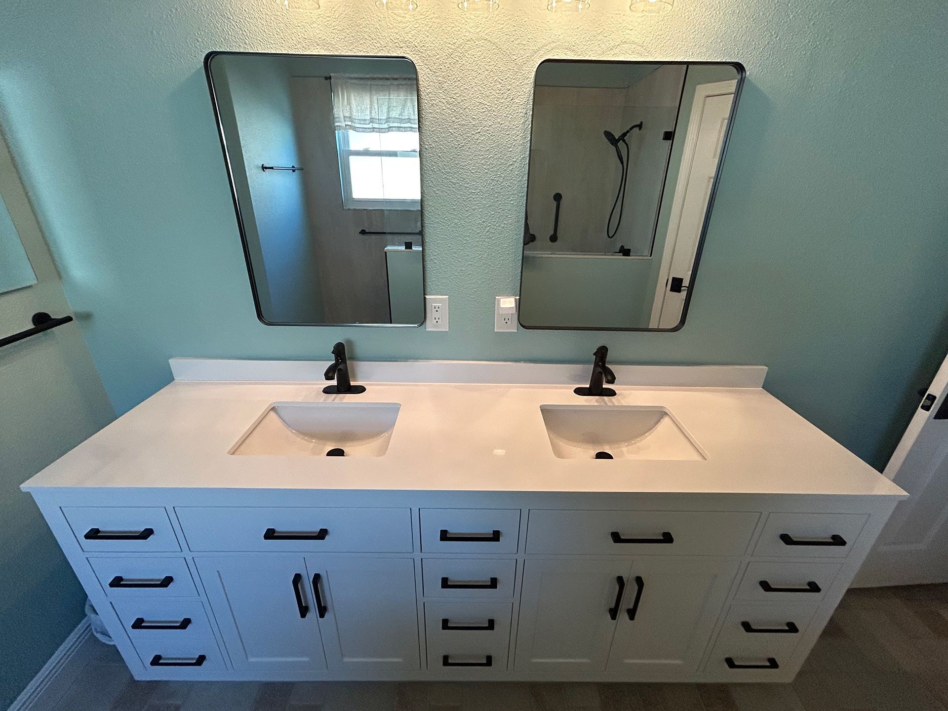 A bathroom with two sinks and two mirrors