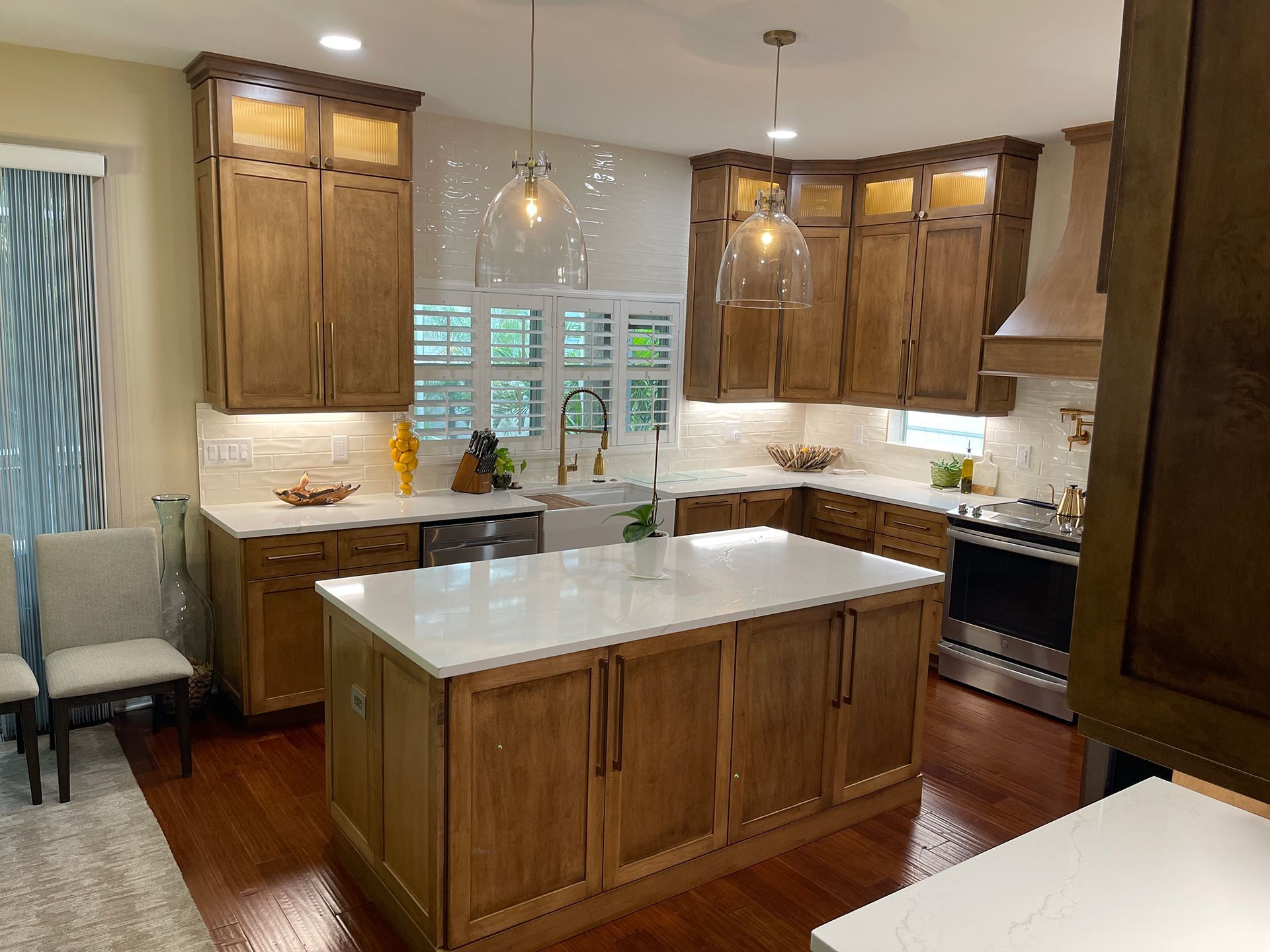 A kitchen with wooden cabinets and white counter tops