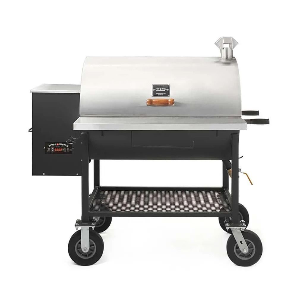 Black and silver smoker grill with a firebox and a stainless steel lid, on a metal cart.