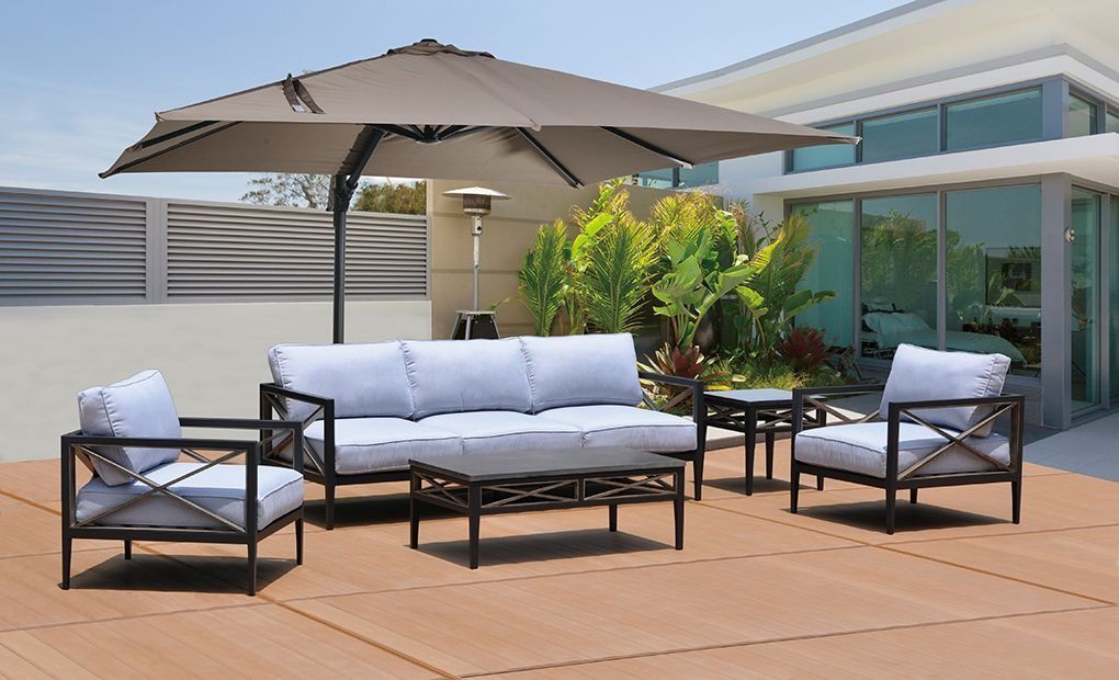 Outdoor patio furniture set with a large umbrella and heater.