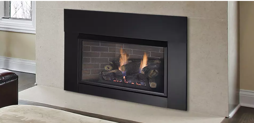 Black framed fireplace with fire burning, set in a light beige wall.