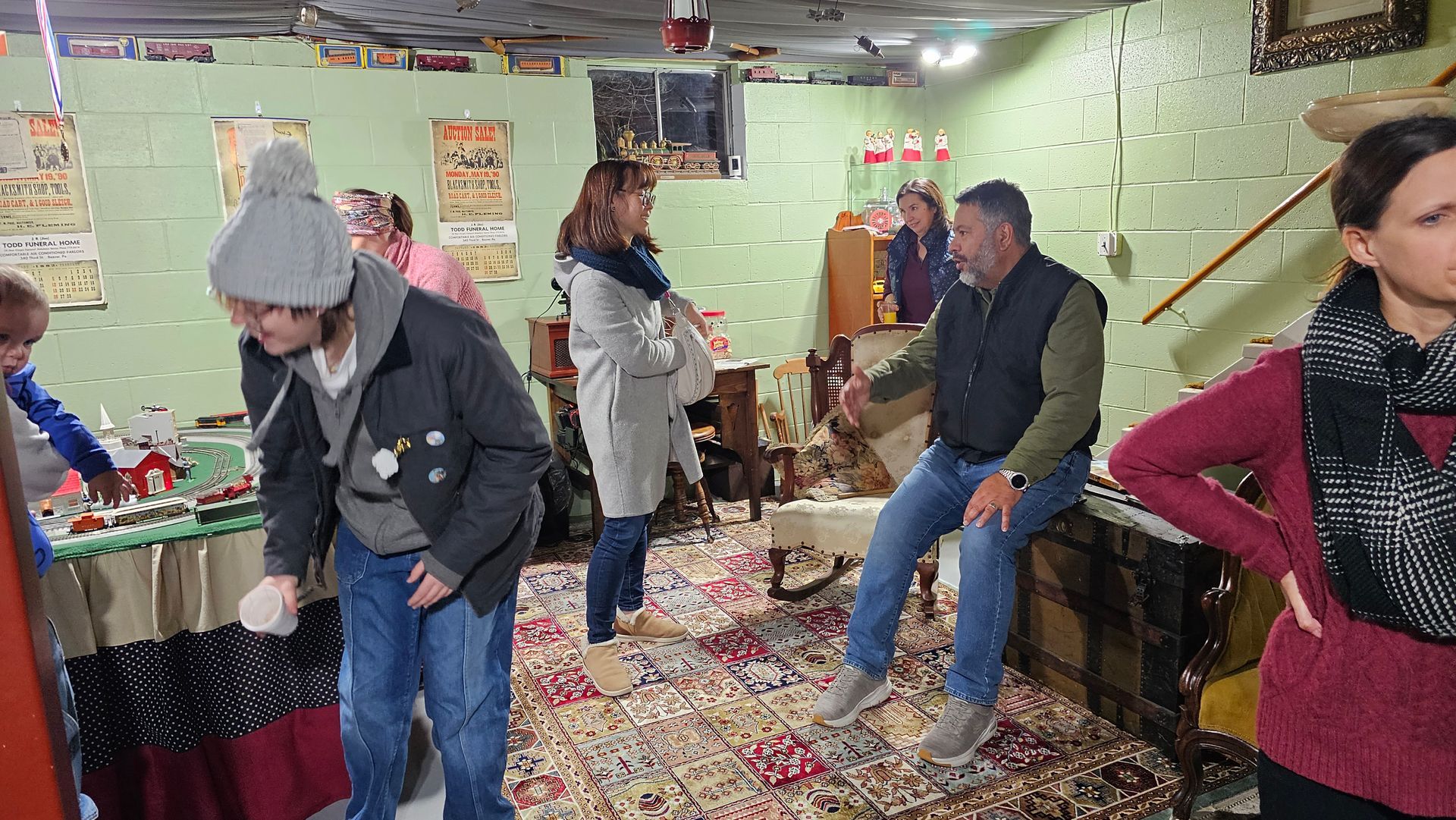 A group of people are standing in a room with confetti on the floor.