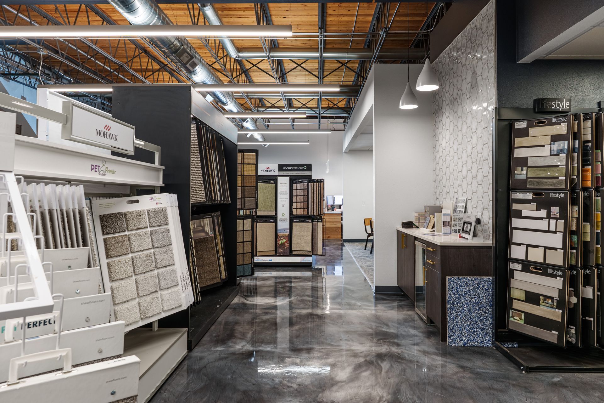 Modern carpet showroom aisle with sample displays and polished concrete floor