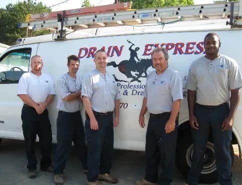 A group of men standing in front of a drain express van