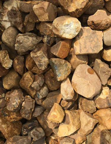Pile of irregularly shaped brown and tan rocks.