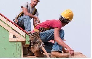 2 men fixing roofs