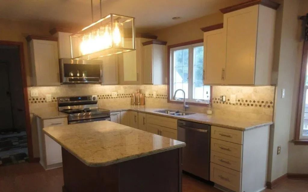 Modern kitchen with island, wood cabinets, stainless appliances, and a window over the sink.