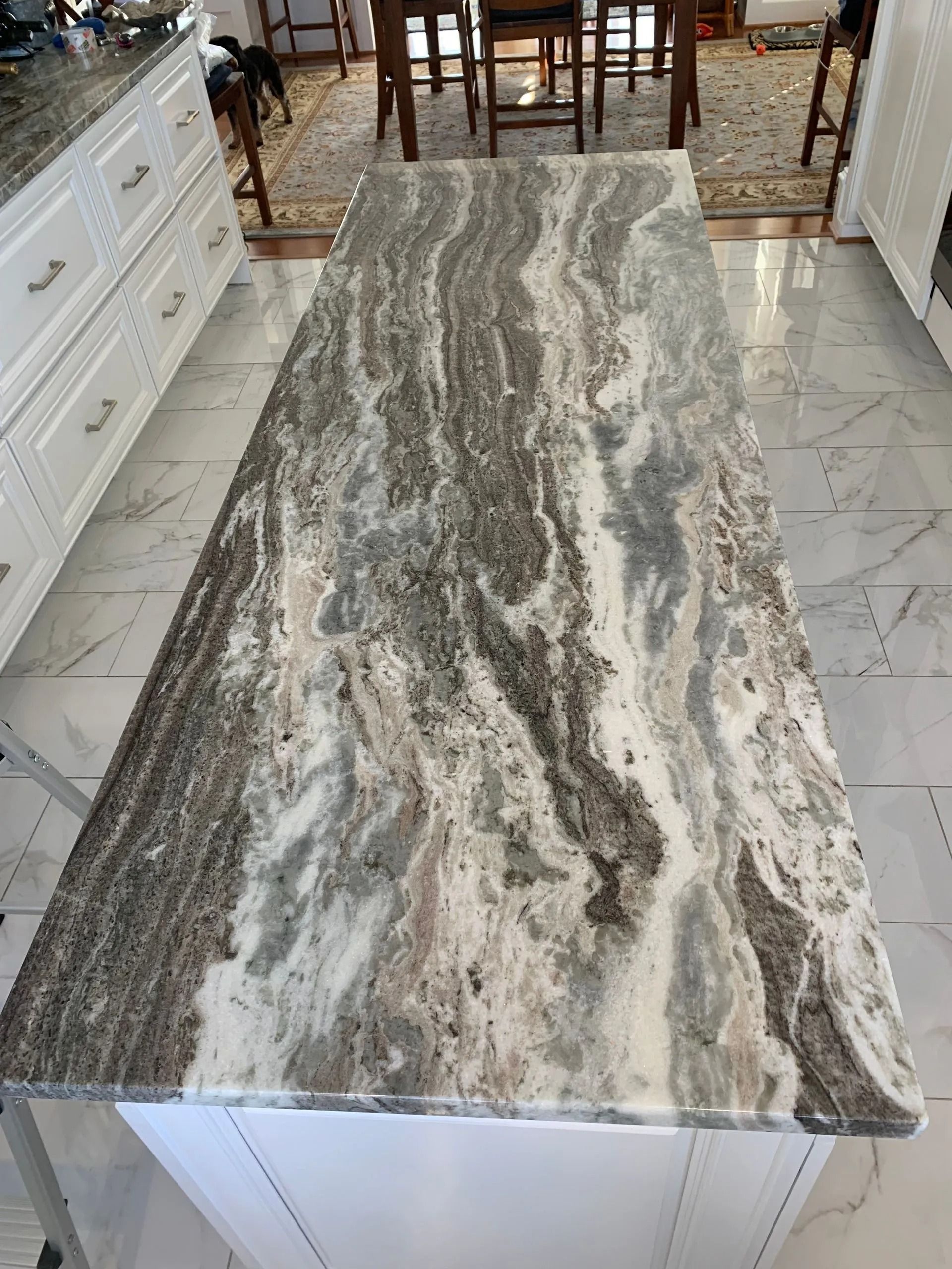 Rectangular stone countertop with gray, white, and brown veining in a kitchen or dining area