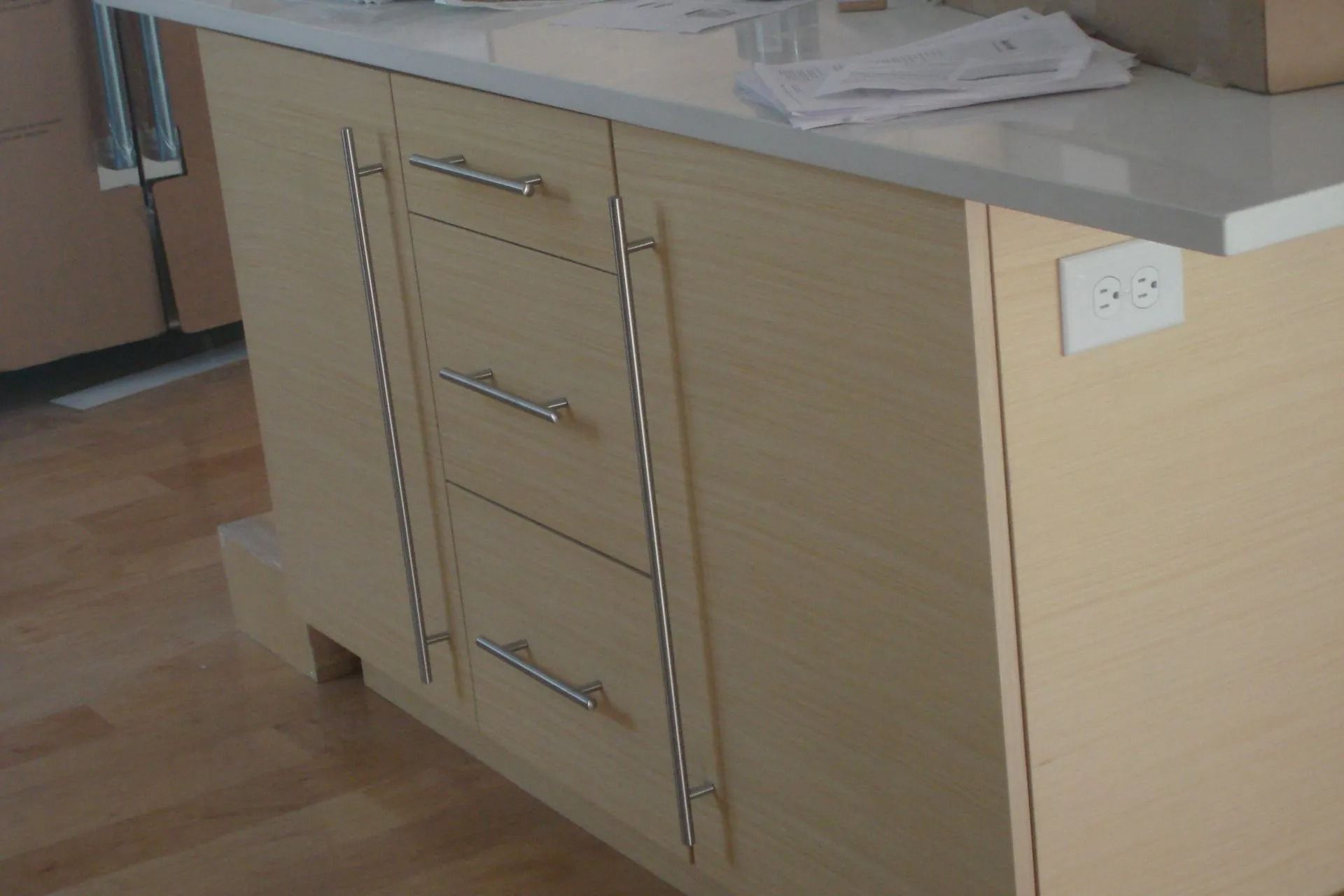Wooden kitchen island cabinet with drawers and countertop in a room