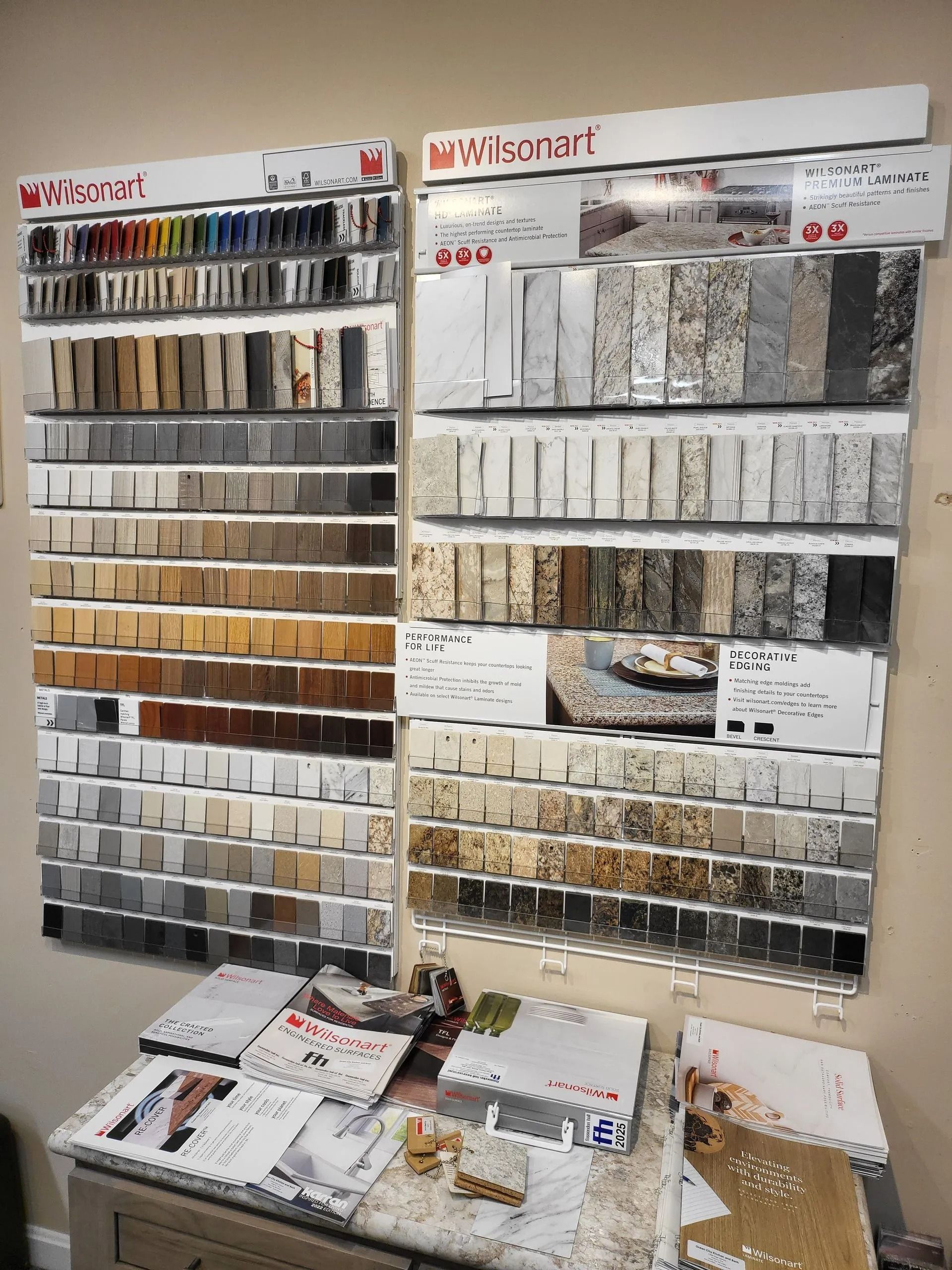 Wall of fabric and tile samples with brochures and product displays in a showroom