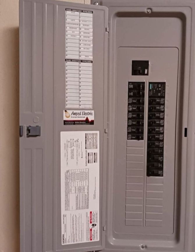 Open electrical breaker panel with door open, showing circuit labels and switches.