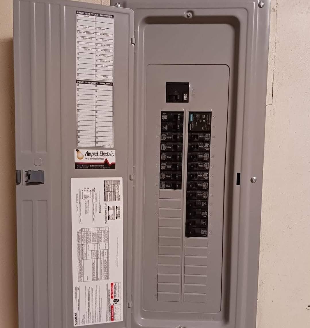 Open electrical breaker panel with door open and circuit labels visible.