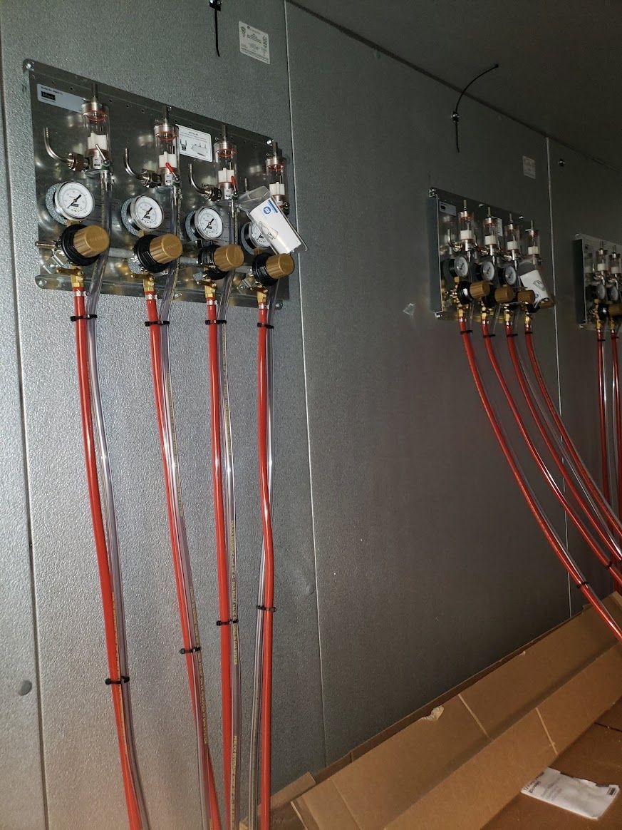 A wall with a bunch of hose connected to it