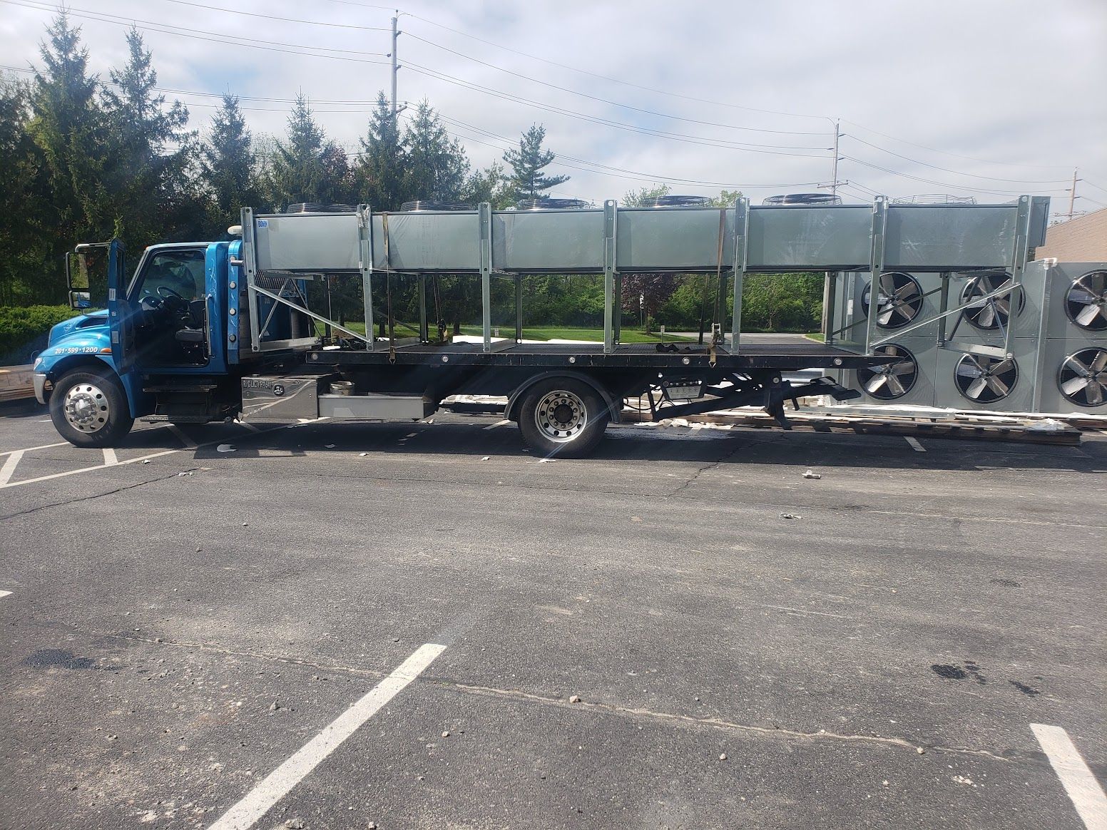 A blue truck is parked in a parking lot.