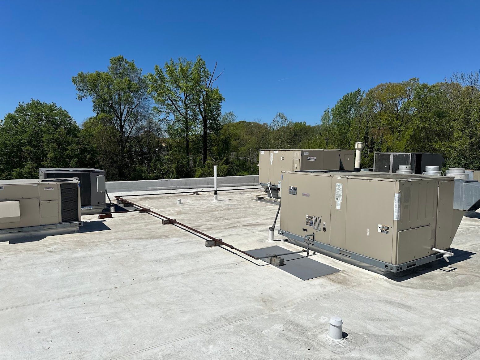 A roof with a lot of air conditioners on it