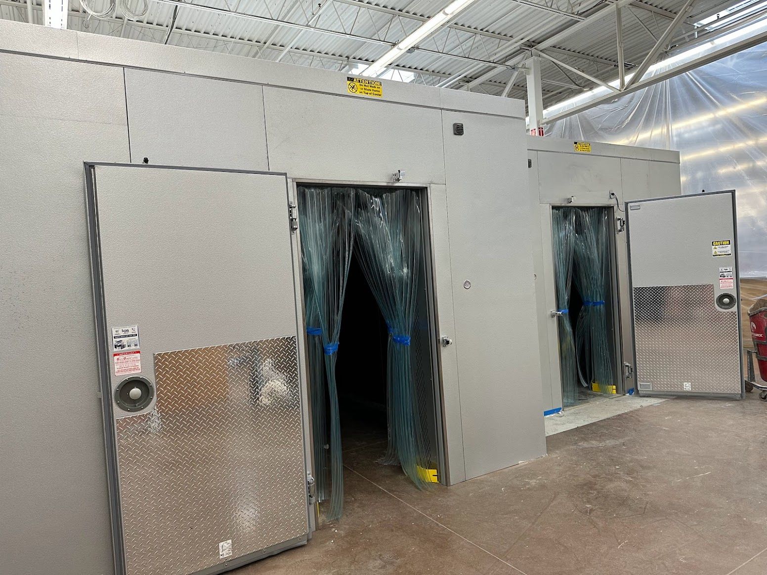 A large room with a lot of doors and curtains.