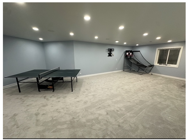 There is a ping pong table in the middle of the room.