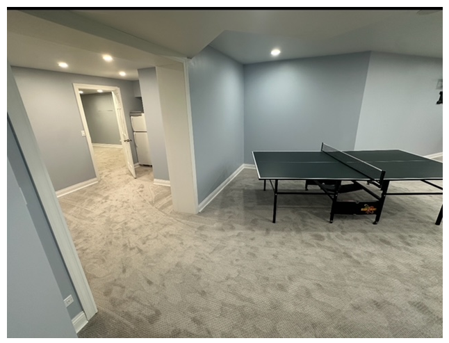 There is a ping pong table in the middle of the room.