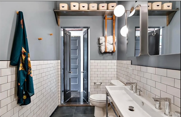 A bathroom with a toilet a sink and a mirror