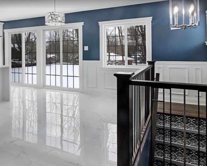 An empty room with blue walls and white trim