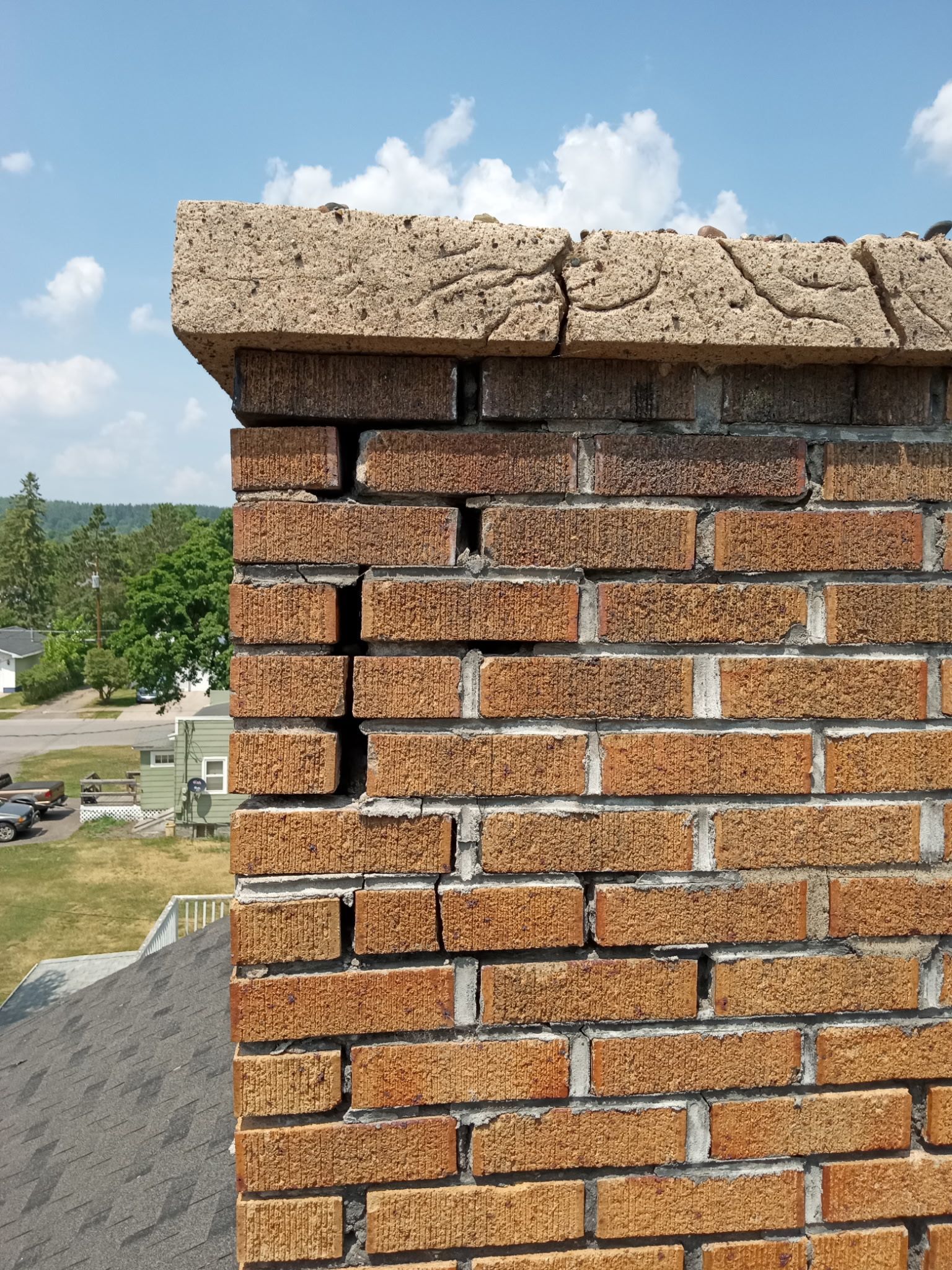 A close up of a brick chimney on a sunny day.