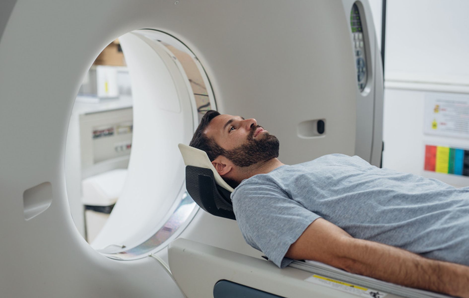 A man is laying in a ct scan machine.