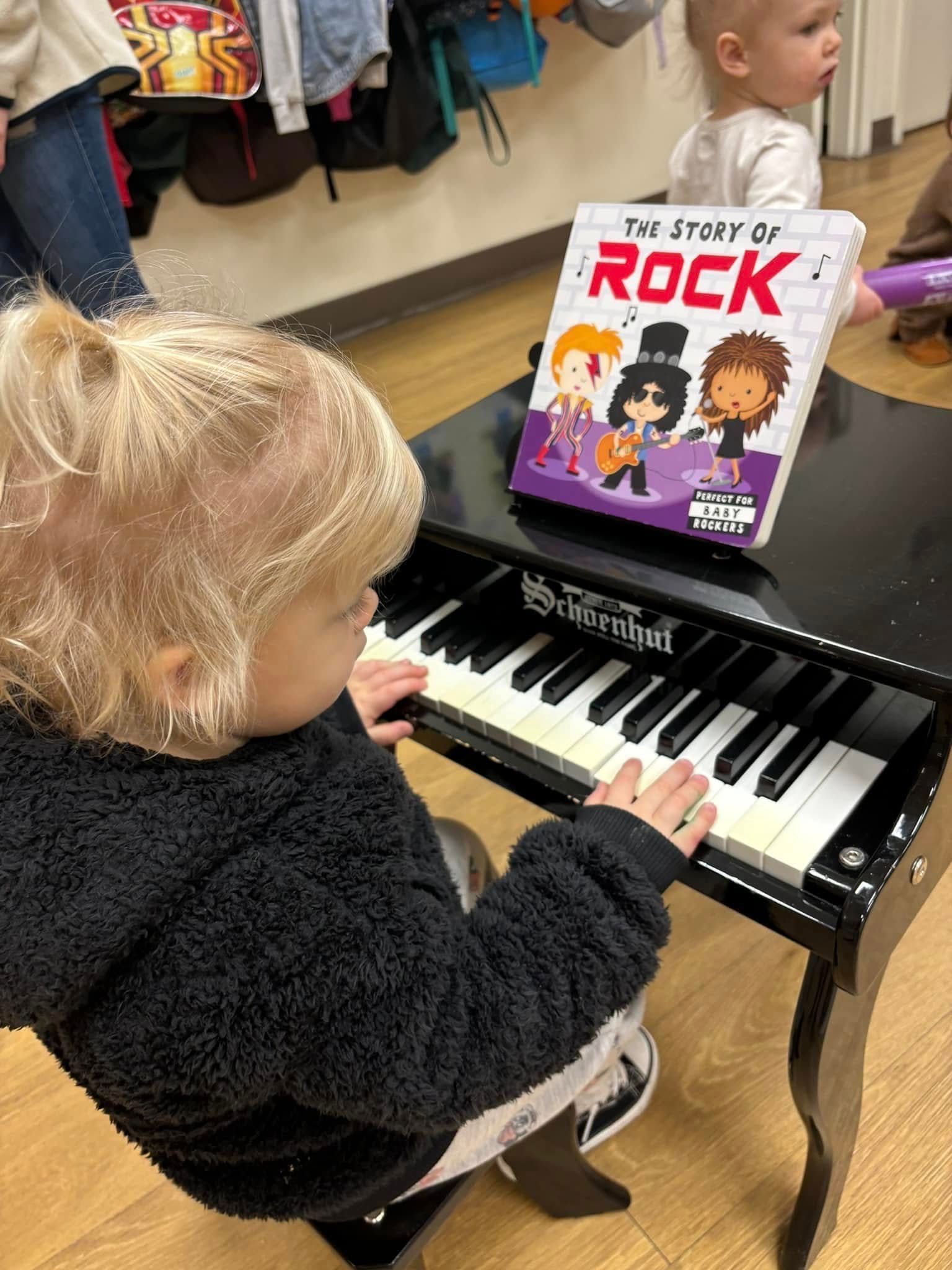 Child playing a toy piano, book 