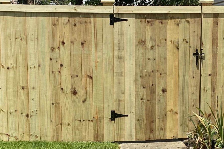 A wooden fence with a gate attached to it.