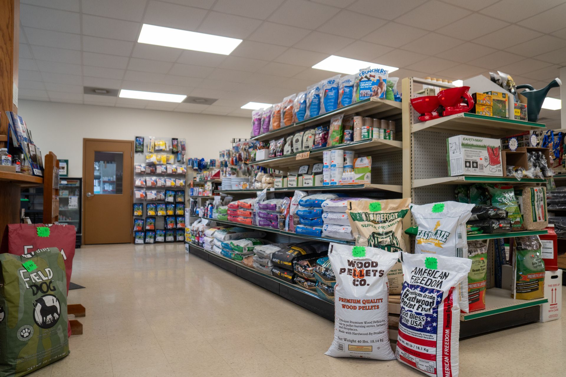 Interior of a pet supply store with shelves of pet food and supplies.