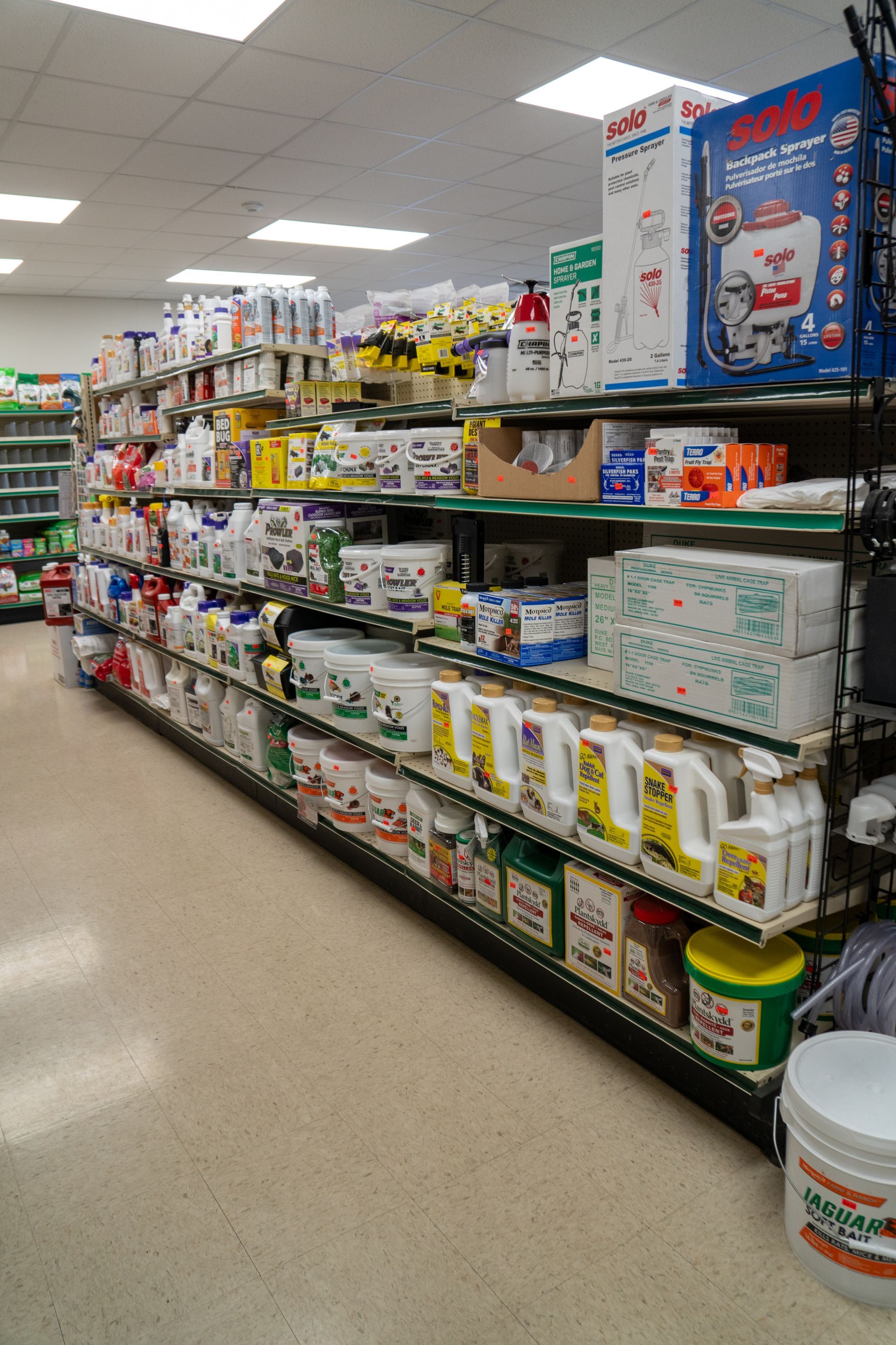 Shelves stocked with gardening and lawn care products in a store.