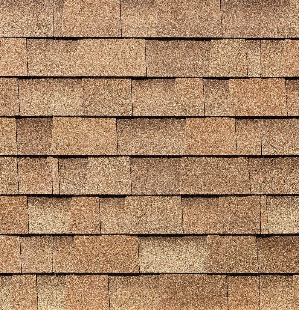 Brown asphalt roof shingles in a brick-like pattern.