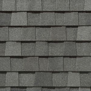 Gray asphalt roof shingles. Overlapping pattern creates a textured surface.