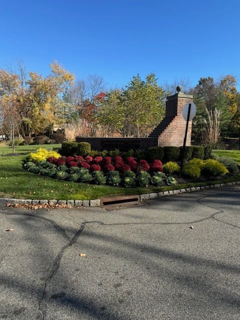 A brick chimney sits in the middle of a garden