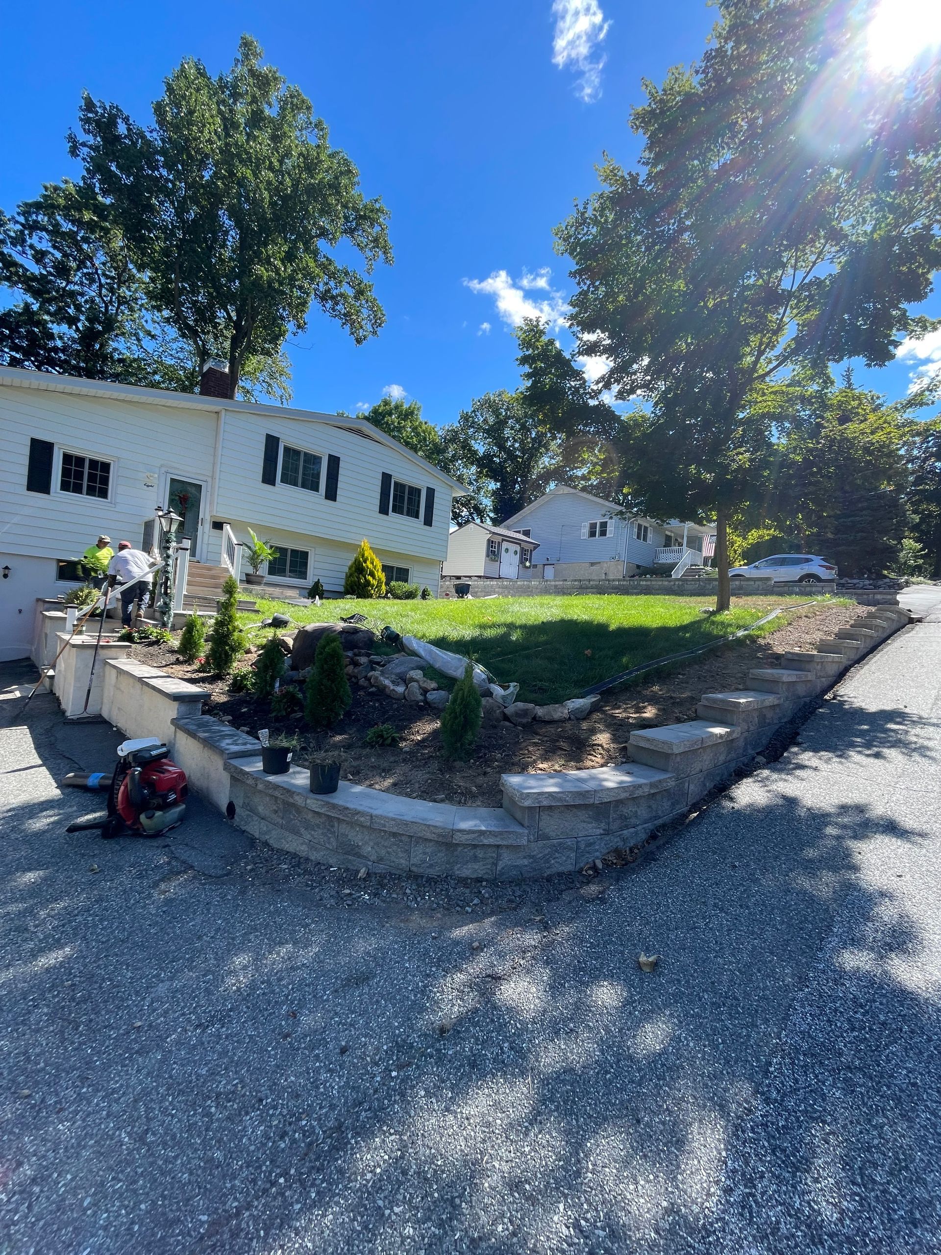 A large white house with a lot of trees in front of it.