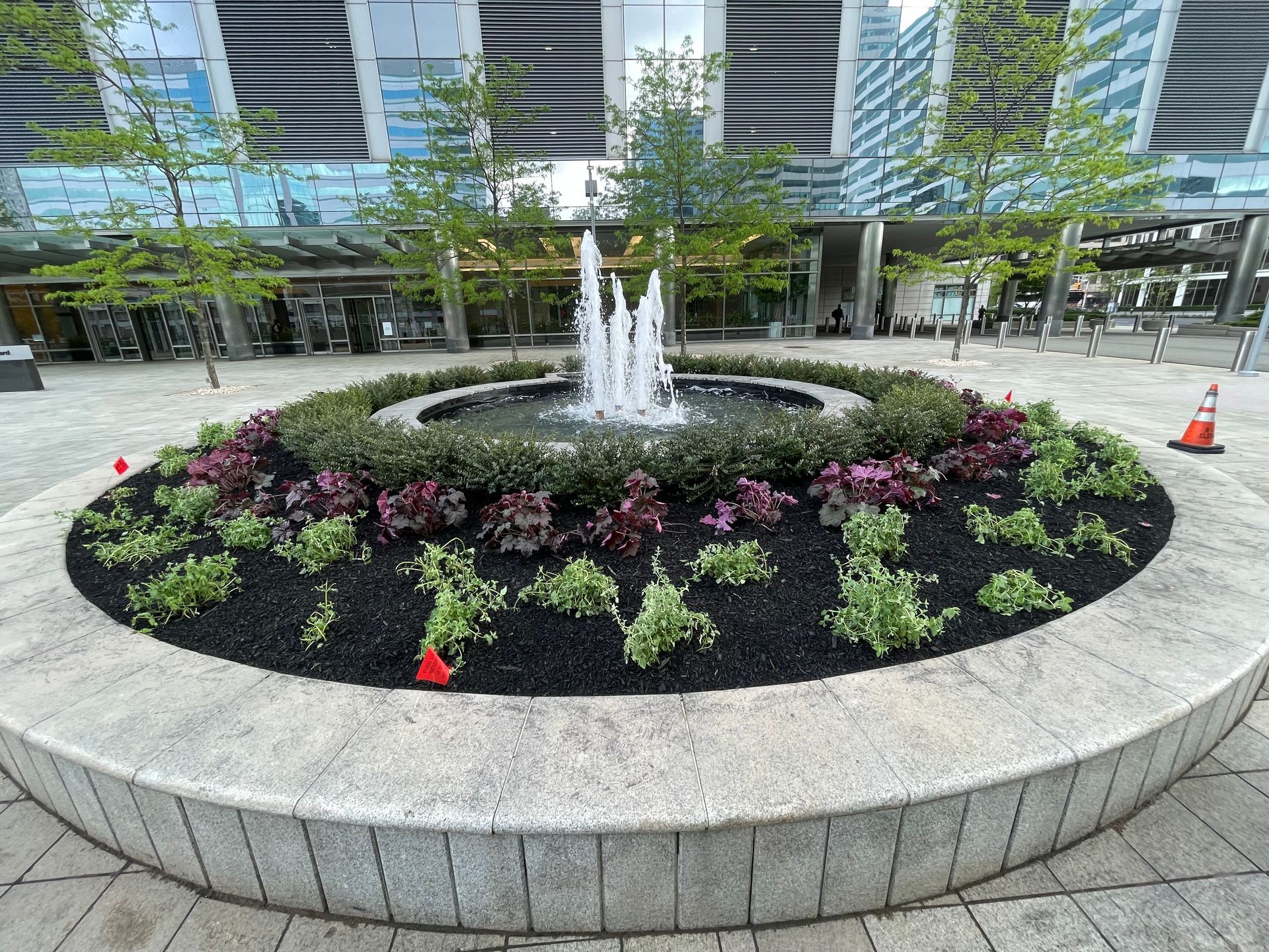 There is a fountain in the middle of a circular garden.