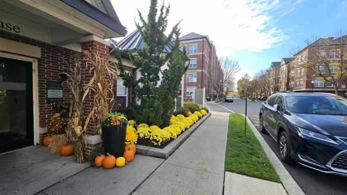 A car is parked on the sidewalk in front of a building.
