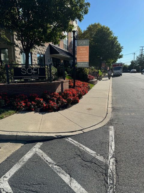 A sidewalk in front of a building that says scott