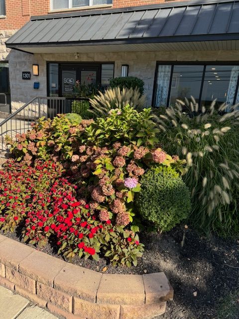 A building with a lot of flowers in front of it