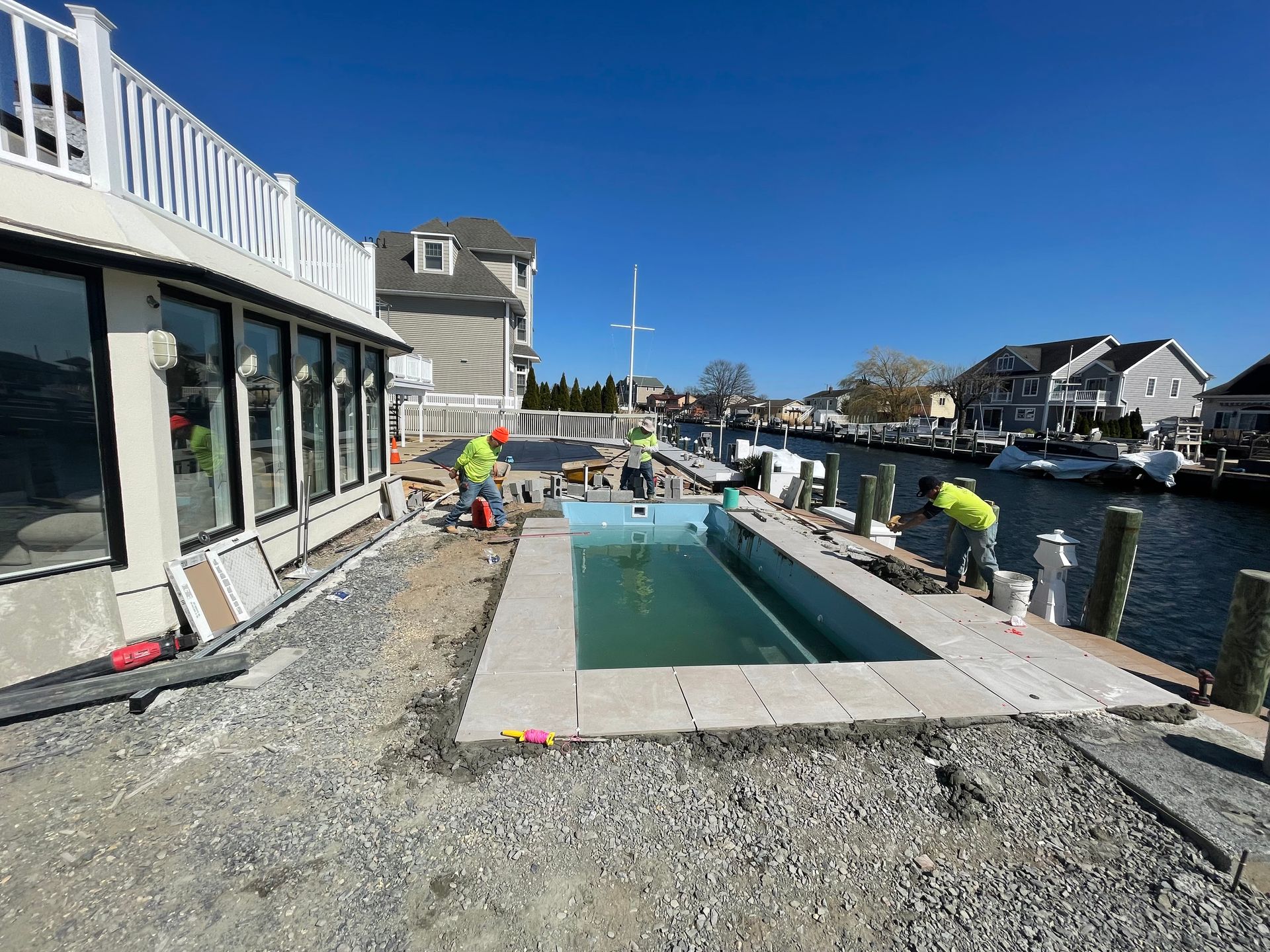 A swimming pool is being built next to a body of water.