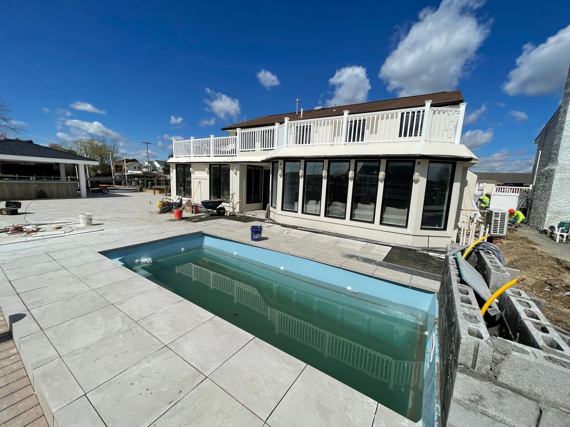 A large house with a swimming pool in front of it.