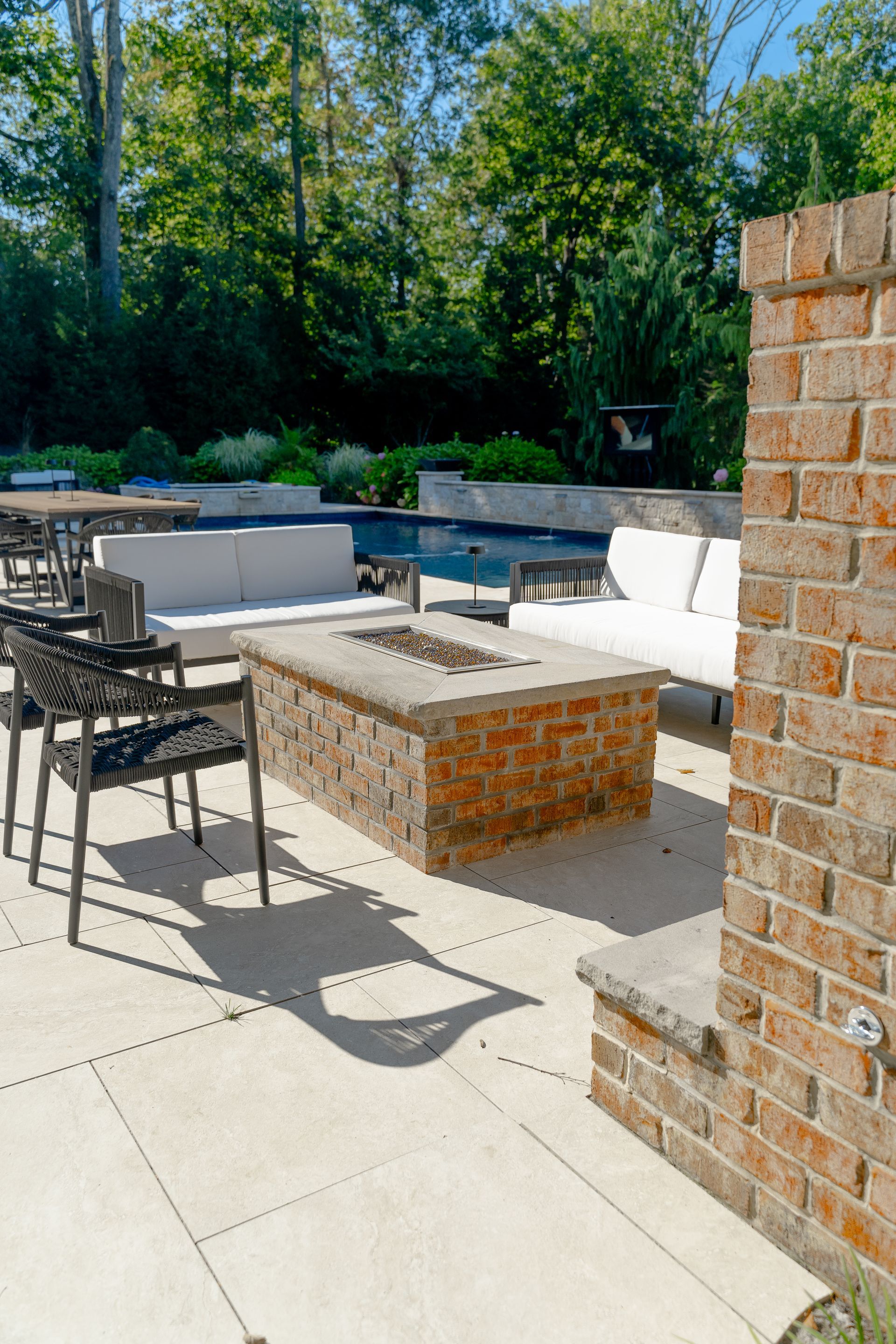 There is a fire pit in the middle of the patio.