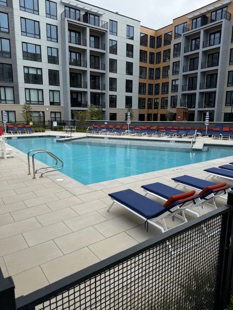 A large swimming pool in front of a building