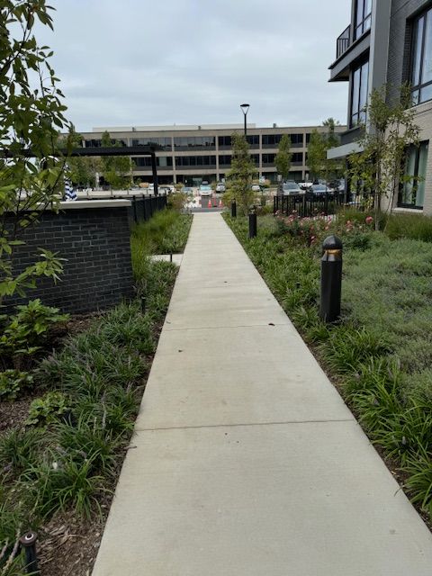 A concrete walkway leading to a parking garage