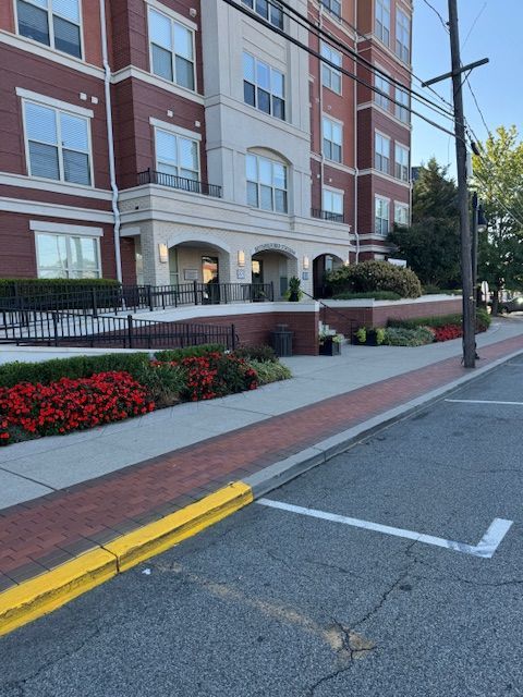 A brick building with a yellow curb in front of it