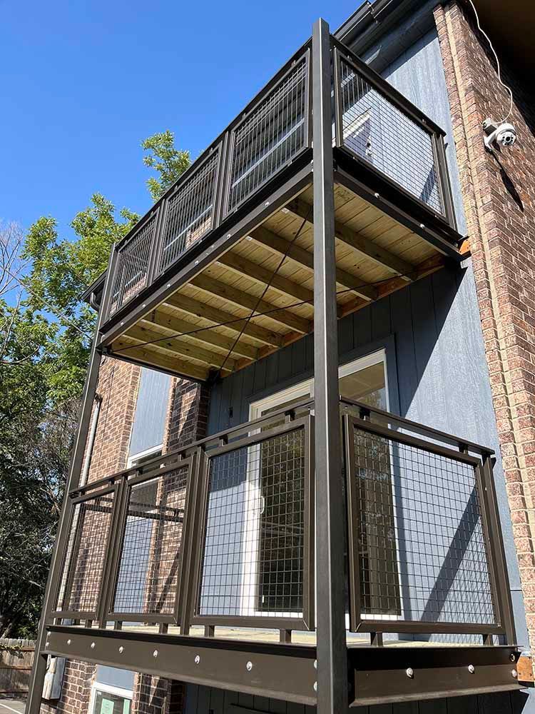 There is a balcony on the side of a building.