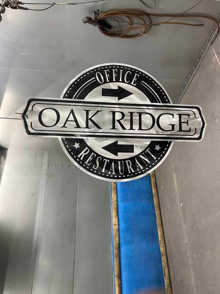 A sign for oak ridge restaurant is hanging from the ceiling