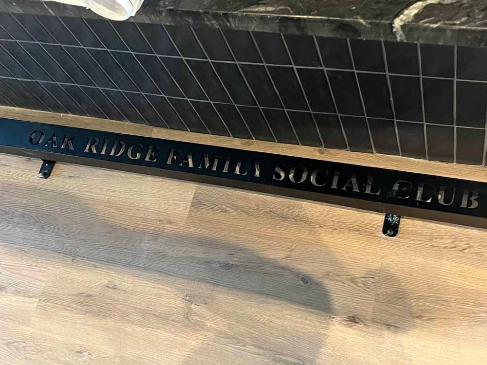A black bench with the words van ridge family social club written on it.