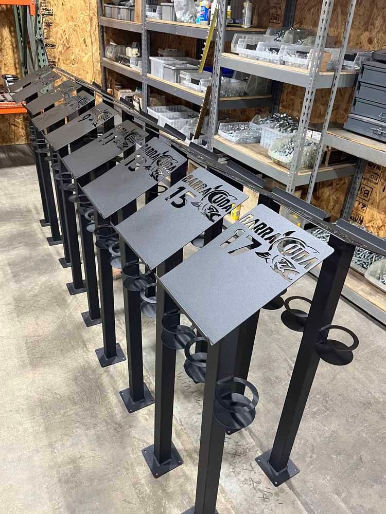 A row of metal signs are lined up in a warehouse.