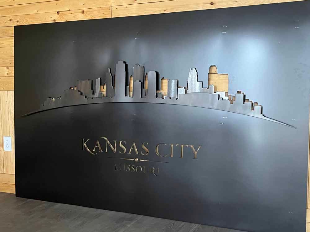 A large black sign that says kansas city on it