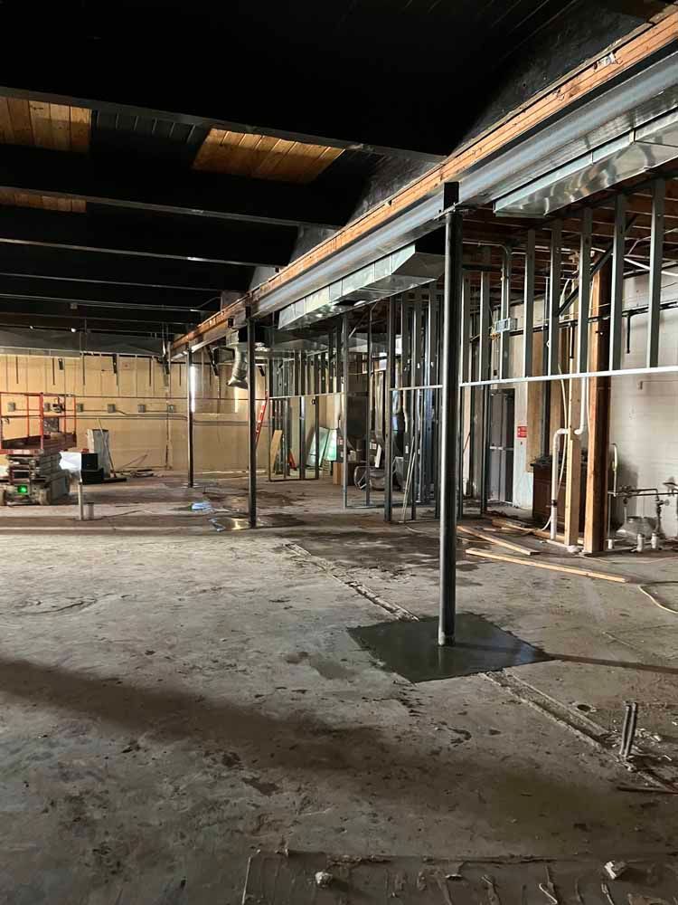 The inside of a building under construction with a lot of metal beams.